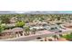 High angle aerial of home in the neighborhood with lush trees and mountain views at 5119 E Shaw Butte Dr, Scottsdale, AZ 85254