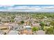 An aerial view of a neighborhood showcasing mature trees, well-maintained streets, and scenic mountain backdrop at 5119 E Shaw Butte Dr, Scottsdale, AZ 85254