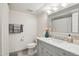 Well-lit bathroom with a marble countertop vanity, framed mirror, and neutral color scheme at 5119 E Shaw Butte Dr, Scottsdale, AZ 85254