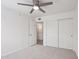 Bright bedroom with a ceiling fan, spacious closet, carpet, and neutral paint at 5119 E Shaw Butte Dr, Scottsdale, AZ 85254