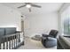 Neutral Bedroom featuring crib, plush chair, ceiling fan, and plenty of room to play at 5119 E Shaw Butte Dr, Scottsdale, AZ 85254