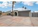 Contemporary home with desert landscaping, a two-car garage, and a neutral-colored exterior at 5119 E Shaw Butte Dr, Scottsdale, AZ 85254
