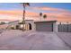 Charming single-story home with desert landscaping, a two-car garage, and a neutral-colored exterior at 5119 E Shaw Butte Dr, Scottsdale, AZ 85254
