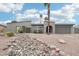 Inviting single-story home featuring desert landscaping, a palm tree, and a two-car garage at 5119 E Shaw Butte Dr, Scottsdale, AZ 85254