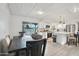 Open-concept kitchen and dining area featuring an island with seating and outdoor access at 5119 E Shaw Butte Dr, Scottsdale, AZ 85254