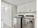 Bright laundry room equipped with newer stainless steel washer and dryer and ample storage space at 5119 E Shaw Butte Dr, Scottsdale, AZ 85254