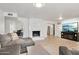 Cozy living room with wood-look tile flooring and modern fireplace, ideal for relaxing and entertaining at 5119 E Shaw Butte Dr, Scottsdale, AZ 85254