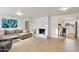 Bright living room features a decorative fireplace and an open floor plan leading into the kitchen at 5119 E Shaw Butte Dr, Scottsdale, AZ 85254