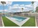 View of pool with blue chairs, a fence and palm trees at 5119 E Shaw Butte Dr, Scottsdale, AZ 85254