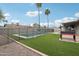 Backyard pool with surrounding grass and privacy fence and grill at 5119 E Shaw Butte Dr, Scottsdale, AZ 85254