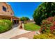 Inviting backyard featuring green lawn, trees, and a patio area at 5216 W Oraibi Dr, Glendale, AZ 85308