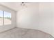 Bright, neutral bedroom featuring a ceiling fan and a window with outdoor views at 5216 W Oraibi Dr, Glendale, AZ 85308