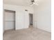 Bedroom featuring neutral carpet, ceiling fan and closet with sliding doors at 5216 W Oraibi Dr, Glendale, AZ 85308
