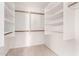 Walk-in closet featuring white shelving and ample storage space at 5216 W Oraibi Dr, Glendale, AZ 85308