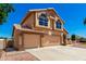 Beautiful two-story home with a three car garage, desert landscaping and a view of palm trees at 5216 W Oraibi Dr, Glendale, AZ 85308
