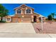 Charming two-story home with a three car garage and a well manicured yard with mature landscaping at 5216 W Oraibi Dr, Glendale, AZ 85308