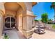 A lovely tiled front porch and yard with a decorative pineapple fountain at 5216 W Oraibi Dr, Glendale, AZ 85308