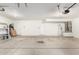 Spacious garage with lighting, doors, and concrete flooring at 5216 W Oraibi Dr, Glendale, AZ 85308