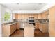 Bright kitchen with granite countertops, stainless steel appliances and hardwood floors at 5216 W Oraibi Dr, Glendale, AZ 85308