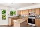 Bright kitchen with granite countertops, center island, and stainless steel dishwasher at 5216 W Oraibi Dr, Glendale, AZ 85308