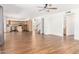 Open floor plan with hardwood floors, neutral paint and view into kitchen and staircase at 5216 W Oraibi Dr, Glendale, AZ 85308