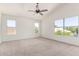 Spacious bedroom with neutral carpet and three large windows offering lots of natural light at 5216 W Oraibi Dr, Glendale, AZ 85308