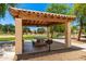 Community picnic area featuring shaded structure, grill, and concrete picnic table with benches at 5216 W Oraibi Dr, Glendale, AZ 85308