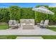 Outdoor living area with modern seating, a cozy fire pit, a soothing water feature, and lush landscaping at 5542 E Alan Ln, Paradise Valley, AZ 85253