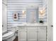 Stylish bathroom with blue and white striped walls, a modern vanity, and white subway tile in the shower at 5542 E Alan Ln, Paradise Valley, AZ 85253