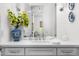 Elegant bathroom featuring white subway tile, quartz countertop, and a vibrant blue decorative flower vase at 5542 E Alan Ln, Paradise Valley, AZ 85253
