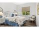 Cozy bedroom with hardwood floors, neutral walls, and a plush bed with blue and white accents at 5542 E Alan Ln, Paradise Valley, AZ 85253