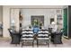 Elegant outdoor dining area with black and white chairs, an outdoor fireplace, and views of the landscaped yard at 5542 E Alan Ln, Paradise Valley, AZ 85253