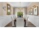 Formal dining room features crown molding, wainscoting, and designer light fixtures at 5542 E Alan Ln, Paradise Valley, AZ 85253