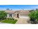 Beautiful single-story home featuring a three-car garage, stone accents, manicured landscaping, and tile roof at 5542 E Alan Ln, Paradise Valley, AZ 85253