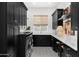 Modern laundry room with dark cabinets, white countertops, patterned tile floor, and stainless steel appliances at 5542 E Alan Ln, Paradise Valley, AZ 85253