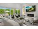 Spacious living room with a fireplace, TV, and sliding glass doors to the outdoor patio at 5542 E Alan Ln, Paradise Valley, AZ 85253