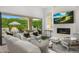 Spacious living room with a fireplace, TV, and sliding glass doors to the outdoor patio at 5542 E Alan Ln, Paradise Valley, AZ 85253