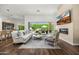 Sun-filled living room showcases an elegant fireplace and views of the outdoor patio at 5542 E Alan Ln, Paradise Valley, AZ 85253