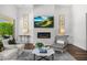Bright living room with fireplace boasts neutral colors, lots of natural light, and hardwood floors at 5542 E Alan Ln, Paradise Valley, AZ 85253