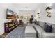 Comfortable office with a large sectional couch, TV, and built-in bookshelves for storage and display at 5542 E Alan Ln, Paradise Valley, AZ 85253
