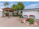 Expansive backyard area with pergola, lush greenery, and vibrant flower beds at 6019 E Windsor Ave, Scottsdale, AZ 85257