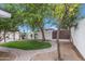 Charming backyard oasis with lush trees, green grass, and brick-paved pathways at 6019 E Windsor Ave, Scottsdale, AZ 85257