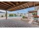 Covered patio view of the refreshing pool, lush landscaping, and brick paver patio at 6019 E Windsor Ave, Scottsdale, AZ 85257