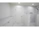 Elegant bathroom with white cabinets, stone counters and walk-in shower at 6019 E Windsor Ave, Scottsdale, AZ 85257