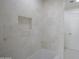 Shower with tiled walls and niche for storage in this bathroom design at 6019 E Windsor Ave, Scottsdale, AZ 85257