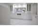 Bathroom featuring double sinks, ample storage and white tile backsplash at 6019 E Windsor Ave, Scottsdale, AZ 85257