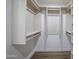 Spacious walk-in closet with custom shelves, drawers, and wood flooring at 6019 E Windsor Ave, Scottsdale, AZ 85257