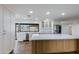 Spacious kitchen with white cabinets, hardwood floors, stainless steel appliances, and an island at 6019 E Windsor Ave, Scottsdale, AZ 85257