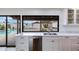 The kitchen features white cabinetry, stainless steel appliances and a view of the pool and backyard at 6019 E Windsor Ave, Scottsdale, AZ 85257