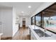 Bright kitchen featuring white cabinets, a stainless steel sink, and views of the pool and outdoor area at 6019 E Windsor Ave, Scottsdale, AZ 85257